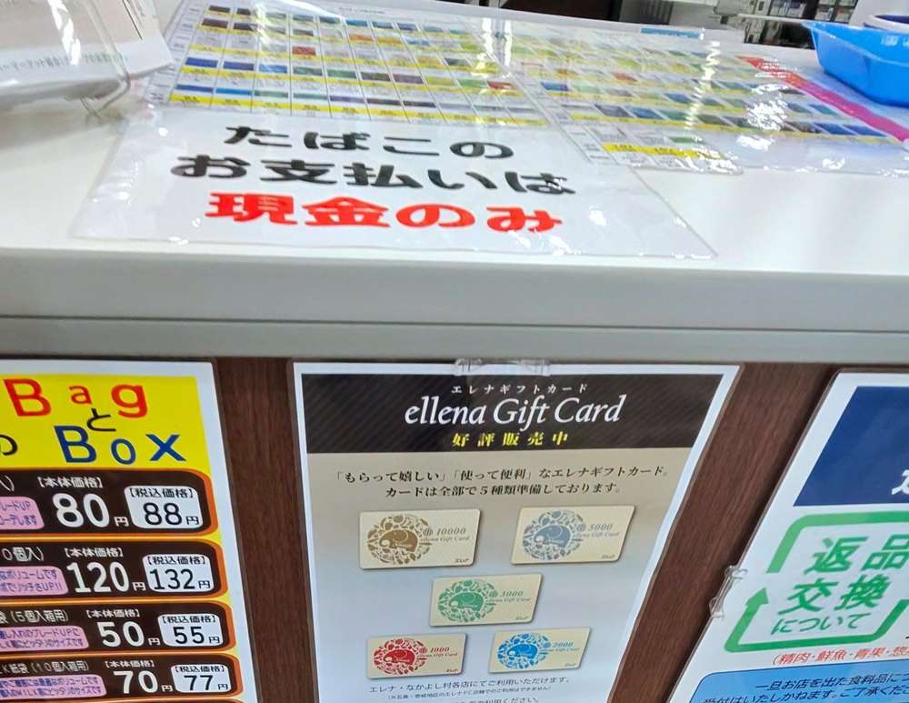 エレナ三和店のカウンター。「たばこのお支払いは現金のみ」の掲示と、エレナギフトカード5種類の案内