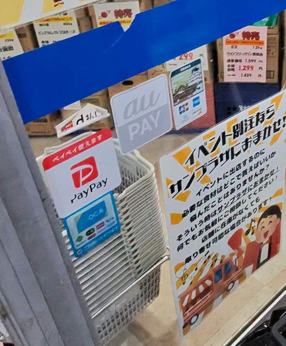 布施店の入口のドアに貼られた支払いの案内。PayPay・au PAY・d払いのマークと、クレジットカードのマーク